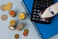 Selective focus of coins and blue toy car on white Royalty Free Stock Photo