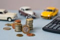 Selective focus of coins and blue toy car on white Royalty Free Stock Photo