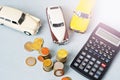 Selective focus of coins and blue toy car on white Royalty Free Stock Photo