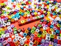 Selective focus.Colorful dice with word DISCOVERY on red background.Shot were noise and film grain.