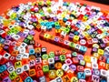 Selective focus.Colorful dice with word DISCOVERY on red background.Shot were noise and film grain.