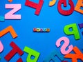 Selective focus.Colorful dice with word FRAUD on blue background.Shot were noise and film grain.