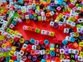 Selective focus.Colorful dice with word LOVE YOU on a red background.Shot were noise and film grain. Royalty Free Stock Photo