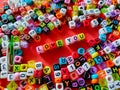 Selective focus.Colorful dice with word LOVE YOU on a red background.Shot were noise and film grain. Royalty Free Stock Photo