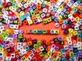 Selective focus.Colorful dice with word TEAM WORK on red background.Shot were noise and film grain. Royalty Free Stock Photo