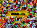 Selective focus.Colorful dice with word THANK YOU on yellow background.Shot were noise and film grain.