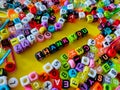 Selective focus.Colorful dice with word THANK YOU on yellow background.Shot were noise and film grain. Royalty Free Stock Photo