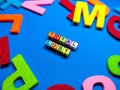 Selective focus.Colorful dice with word TOTAL LOST on blue background.Shot were noise and film grain.