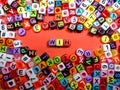 Selective focus.Colorful dice with word WIN on red background.Shot were noise and film grain. Royalty Free Stock Photo