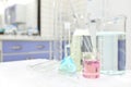 Selective focus of colorful liquid chemicals in glass beaker, flask and tube. Chemistry Laboratory class experiment background.