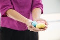 Selective focus colorful multicolor knitting hearts held by female`s both hands, representing helping hands, supports, assistance Royalty Free Stock Photo