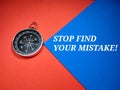 Selective focus.Compass and word STOP FIND YOUR MISTAKE! on a blue and red background.Business concept. Royalty Free Stock Photo