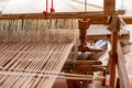 Selective focus of cotton thread on weaver machine. Thai cotton handmade. Homespun fabric process. The process of fabric weaving