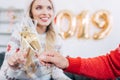 selective focus of couple clinking with champagne glasses and celebrating 2019 Royalty Free Stock Photo