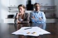 Focus of couple sitting at table with divorce documents