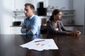 Focus of couple sitting at table with divorce documents