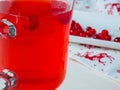 Selective focus on cranberries in a fresh drink in a glass cup