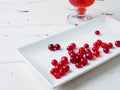 Selective focus on cranberries on a white rectangular ceramic plate