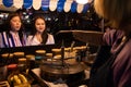 Selective focus of crepe shop and asian young women friends choose order crape cake and wait cooking dessert on hot pan at