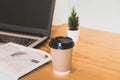 Selective focus on a cup of coffee on work desk