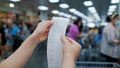 Selective focus customer checking a shopping receipt in a grocery store with blurred background
