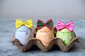 cute blue,orange and green Easter eggs in funny bows Royalty Free Stock Photo