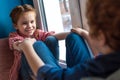 selective focus of cute little kids holding hands and smiling each other while sitting Royalty Free Stock Photo