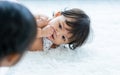 Selective focus cute lovely caucasian little baby girl, put a thumb in mouth, crawling on floor in cozy indoor home, playing with Royalty Free Stock Photo