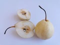 Selective focus of cutted pear and fresh pear isolated on white background. Royalty Free Stock Photo