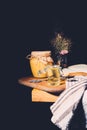 selective focus of cutting board with jars of honey on black