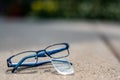 Selective focus on damaged glasses with scratched lens popped out