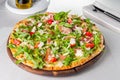 Selective focus Delicious Pizza with hamon and cherry tomato slices, parmezan cheese and arugula on the wooden board on t Royalty Free Stock Photo