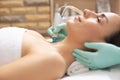 Selective focus of dermabrasion device in the hand of cosmetologist Royalty Free Stock Photo