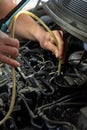 selective focus, detail of a mechanic's hand vacuuming a car engine