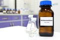 Selective focus of dichloromethane liquid chemical compound in dark glass bottle inside a chemistry laboratory with copy space. Royalty Free Stock Photo