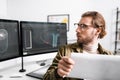 Focus of digital designer holding blueprint