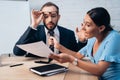 Focus of displeased client holding tie