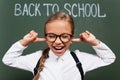 Selective focus of displeased schoolgirl in