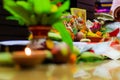 Selective focus. Diwali puja or Laxmi puja set up at home. Oil lamp or diya with crackers, sweet, dry fruits, indian currency,