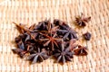 Selective focus of dried star anise on bamboo weave basket.