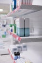 Selective focus of drugstore shelves filled with vitamins and pharmaceutical products to sell prescription medicine