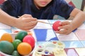 Selective focus. Egg is being painted with little boy for prepareing easter day. Royalty Free Stock Photo