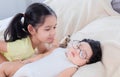 Selective focus of elder sister looking newborn baby while sleeping on bed with love and care. Big sister meeting new toddler kid Royalty Free Stock Photo