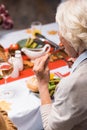 Focus of elderly woman eating cherry Royalty Free Stock Photo