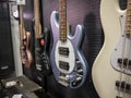 Lynnwood, WA USA - circa May 2022: Selective focus on electric and acoustic bass guitars for sale inside a Guitar Center musical Royalty Free Stock Photo