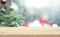 Selective focus.Empty wood table top with blur abstract light bokeh of christmas tree,decoration background Royalty Free Stock Photo