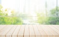 Selective focus.Empty of wood table top on blur of curtain with window and green from garden background Royalty Free Stock Photo
