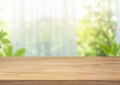 Selective focus.Empty of wood table top on blur of curtain with window view green from garden Royalty Free Stock Photo