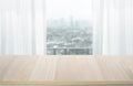 Selective focus.Empty of wood table top on blur of white curtain with window view background Royalty Free Stock Photo
