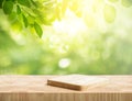 Selective focus.End grain wood counter top with cutting board on blur greeny tree garden in morning background.For montage product